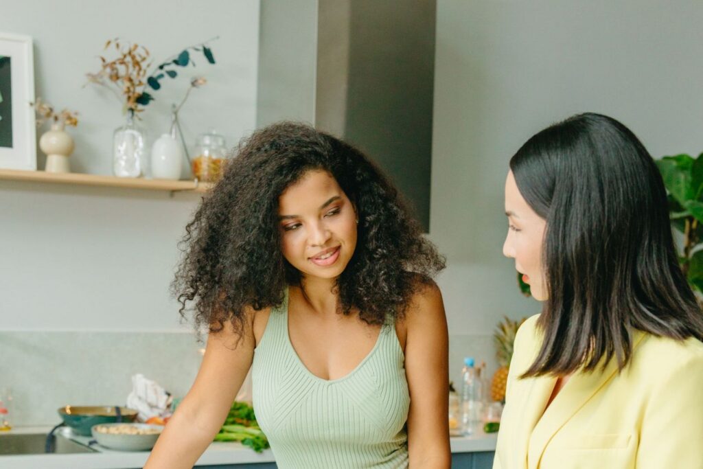 A nutritionist talking with a woman at a kitchen counter about healthy eating
